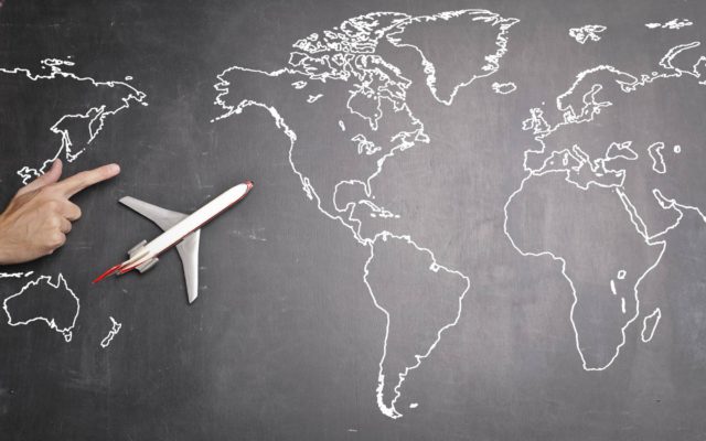 airplane over world map on blackboard